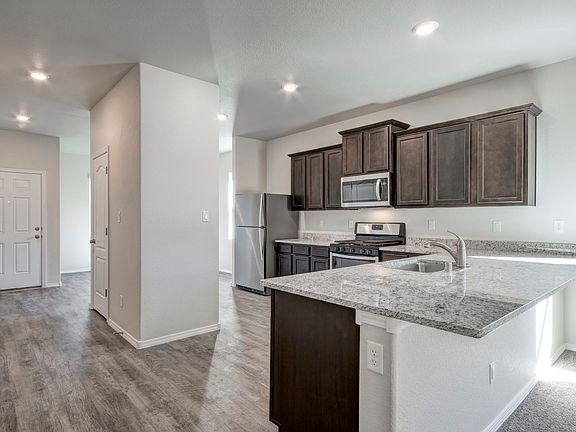 Kitchen with designer upgrades, including stainless steel appliances.