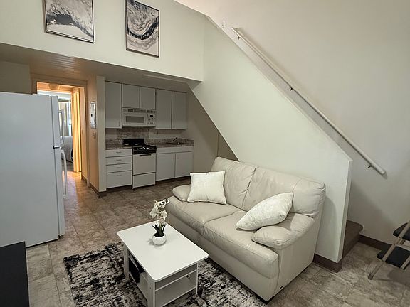 Living Room View w/stair way/kitchen and entrance to bedroom