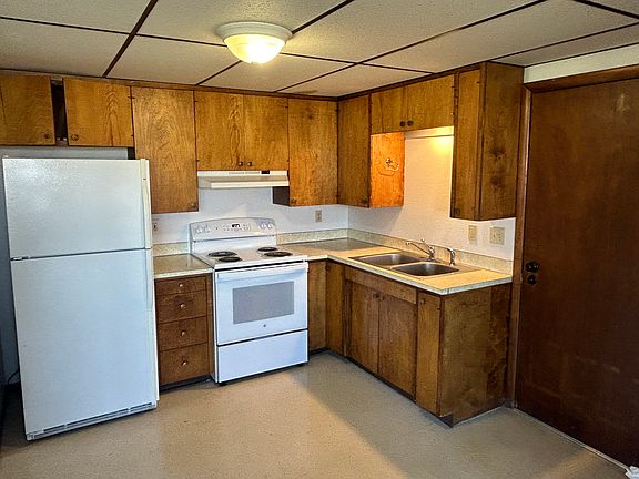 Kitchen with new stove and newer Fridg