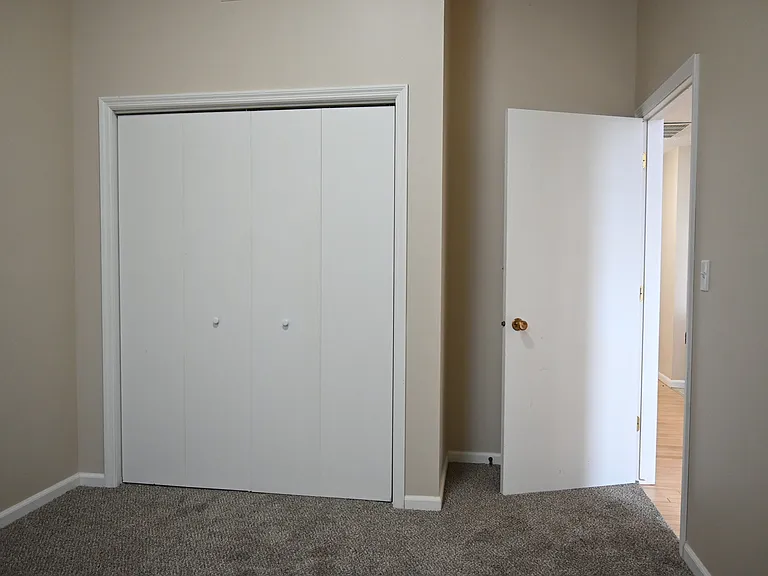 Bedroom with carpet and closet at Rosewater.