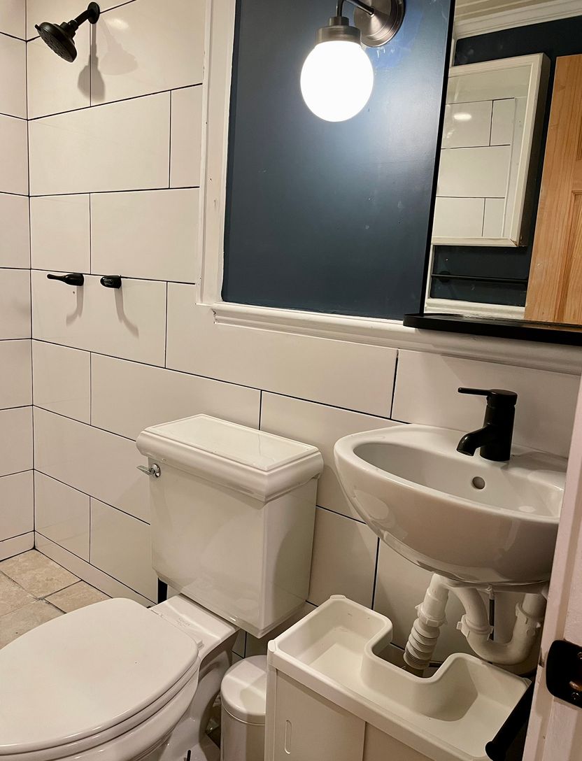  Newly renovated batrhoom with subway tile and big mirror