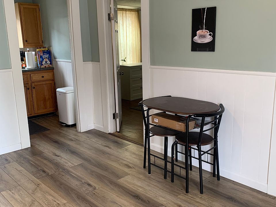 Table area and dish room with sick and additional cabinets for storage.