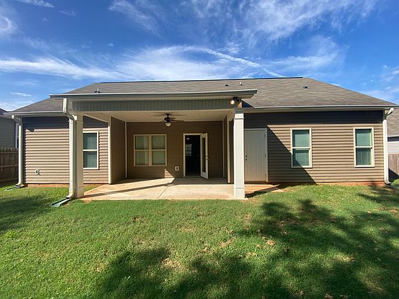 Covered patio with ceiling fan and separate enclosed storage space