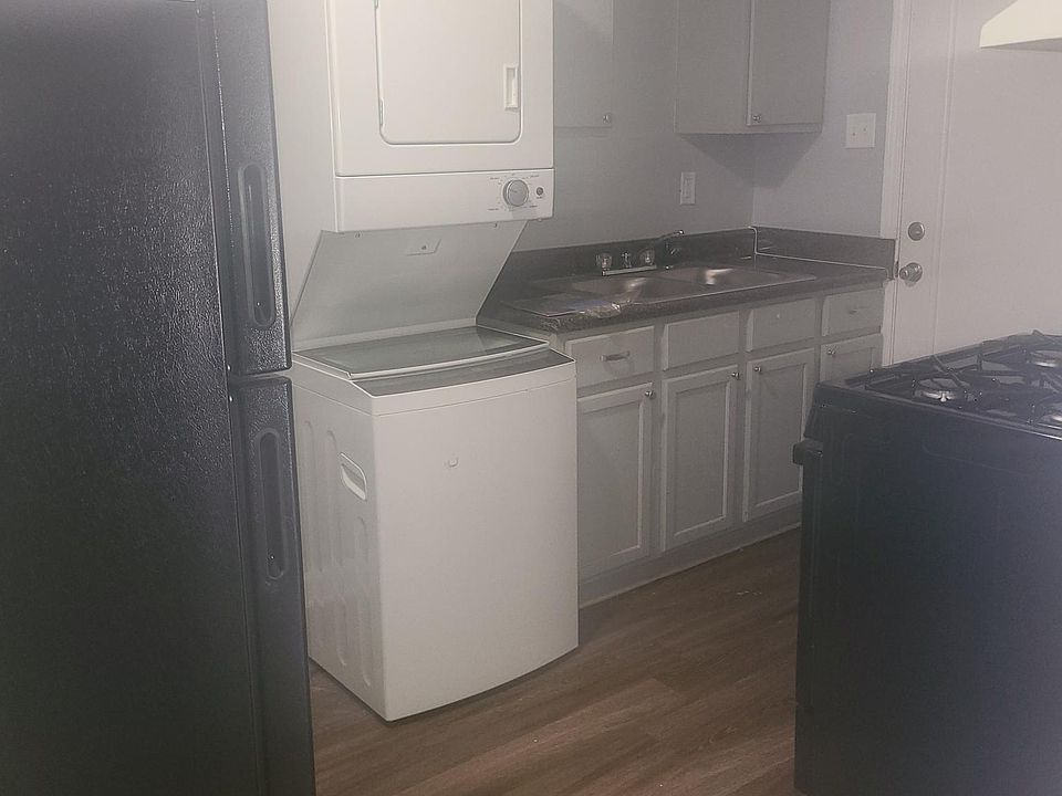 The kitchen has a brand-new black fridge and stove. Washer and dryer come in most units. Some units only have connections.