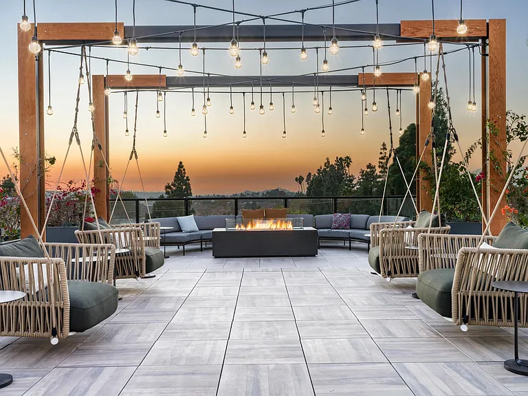 Relax at Modera Pomona's rooftop deck with a firepit and swings_perfect for sunsets, friends, and cozy nights.