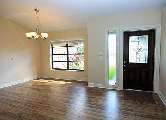 Living Room. Light and bright open concept.  Cathedral ceilings, with sliding doors that pocket back to the porch.  Bring the Florida living in.