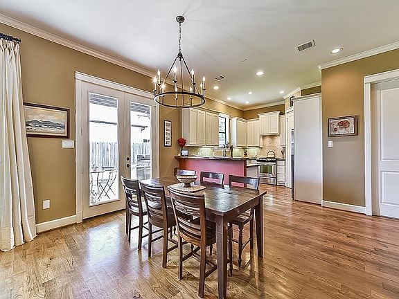 Dining room leading into the kitchen. The Living room/Dining combo has plenty of walkway space and French doors leading to backyard