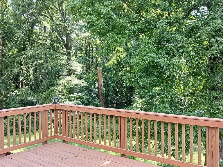 spacious deck with stairs to backyard