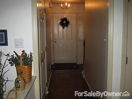Front Entrance - Main Level : Screen door with glass panel. Hardwood floors. Half bathroom.