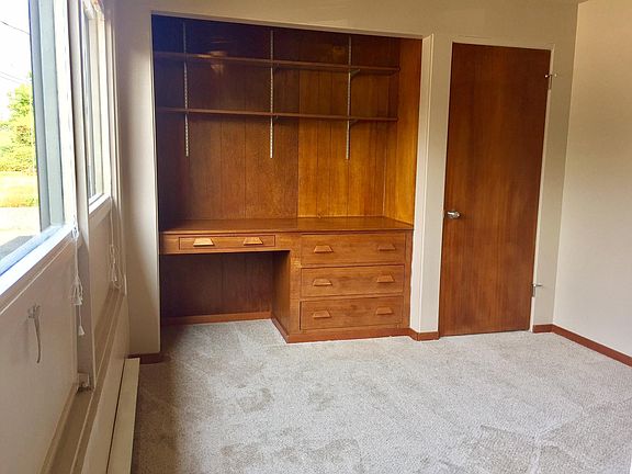 Den with built in desk and closet
