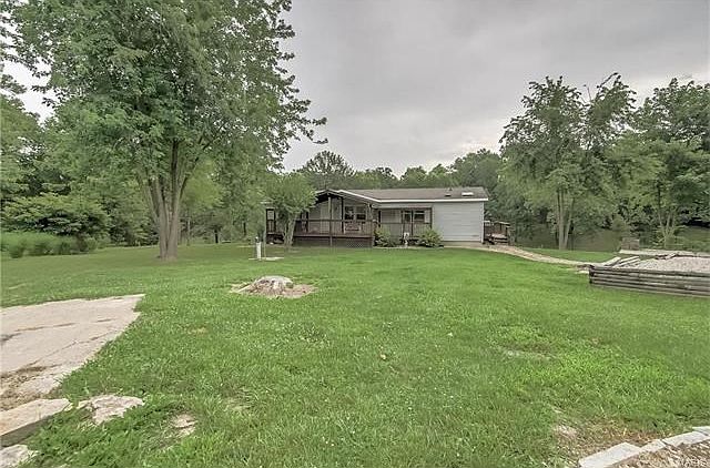 Home is nestled in a park like setting you won't want to leave. Beautiful trees, pasture, and the si