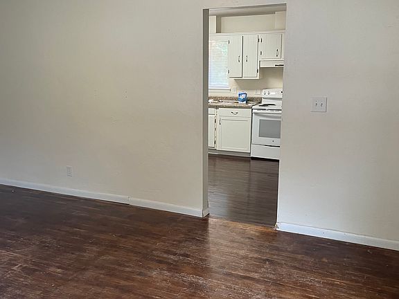 Move from the living room into the eat in kitchen.