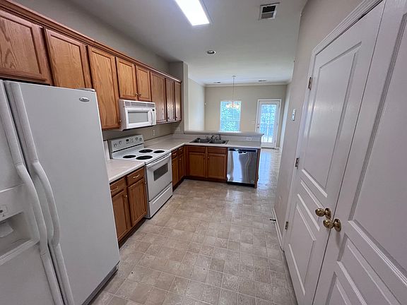 Spacious kitchen with stove, microwave, refrigerator, disposal, and dishwasher included.