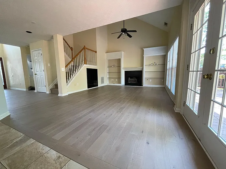 High-ceiling living room, opens to a private backyard and a large deck