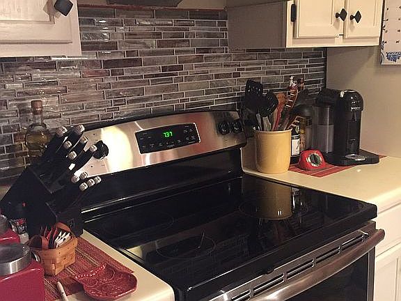 New stove w/ tile backsplash