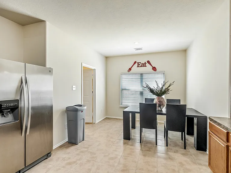 Enjoy some grub in this gorgeous and spacious open concept kitchen with gas stove and stainless steel refrigerator!