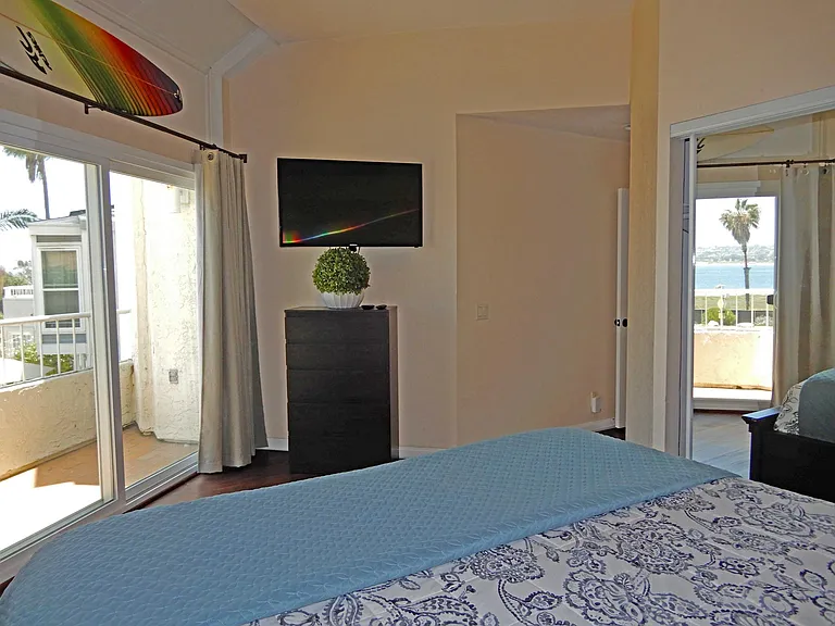 Master bedroom includes smart TV, ensuite bathroom and balcony. View Mission Bay waterfront from bed.