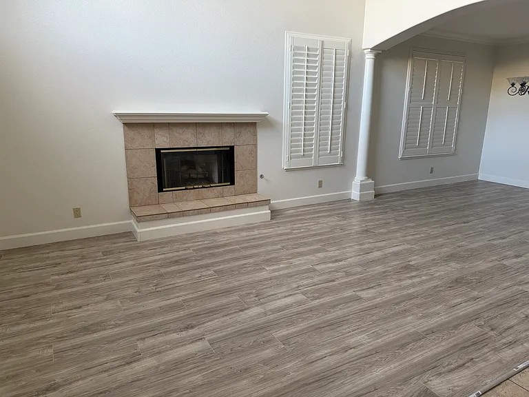 Living room with fireplace and high cieling
