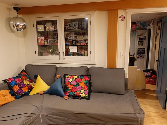 The living room features a built-in glass fronted book case.