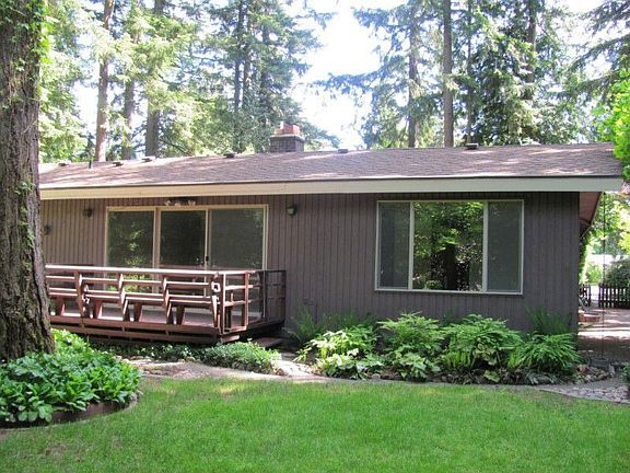 Back view of home and deck. Exterior electrical outlets for convenience.