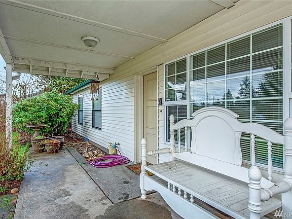Old fashioned covered porch to sit and enjoy year around!