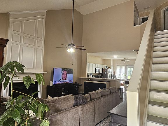 Entrance through the door, Foyer, two story living room and stairs to bedrooms upstairs