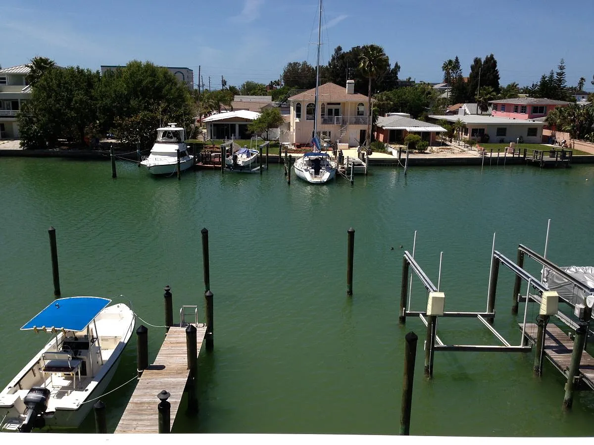 Exterior 2nd Floor Balcony & Boat Lift - 12420 Capri Cir N