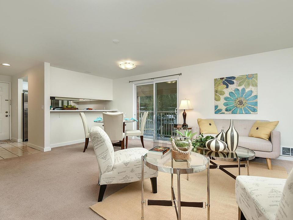 View of the living area and dining area with slider doors to