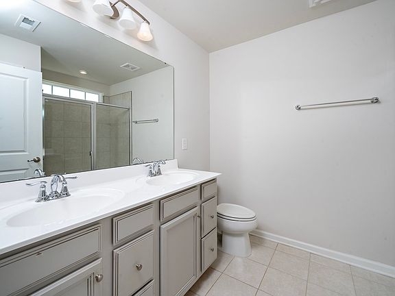 Large master bathroom with double sinks and walk-in shower.