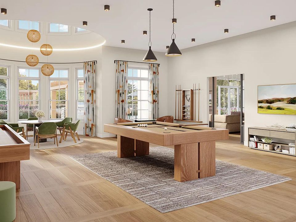 Game room with billiards, shuffleboard, poker table, and comfortable seating at Modera South Shore in Marshfield, MA.
