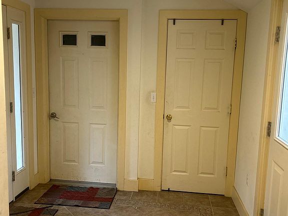 Foyer; garage door and coat closet