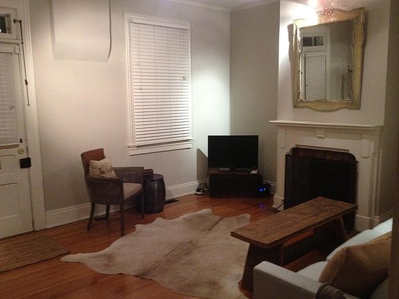 Refinished wood floors with lovely fireplace and mantle