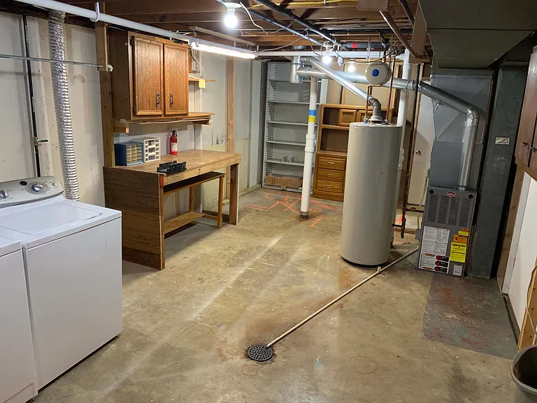 Unfinished basement utility, storage room, work bench