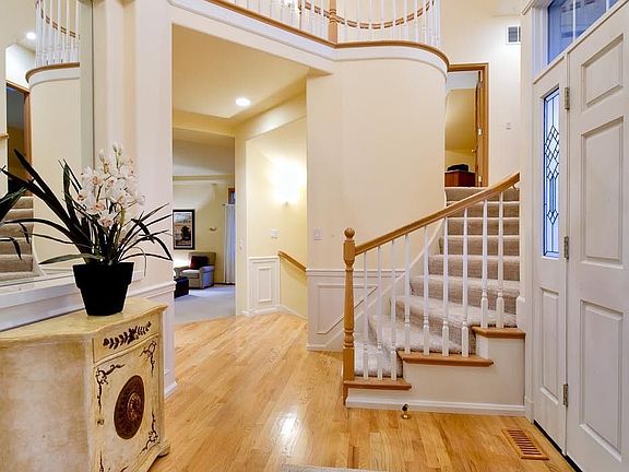 Bright entry showing the curved staircase