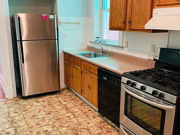 Kitchen. Has dishwahser, stove, and new fridge.