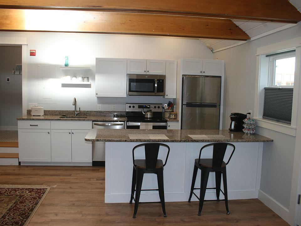 Fully equipped eat-in kitchen with new appliances.