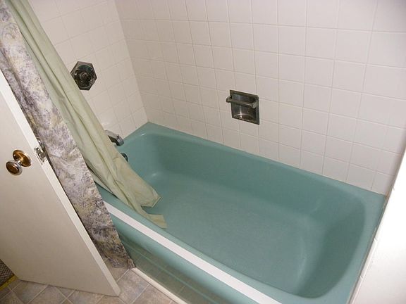 bathroom with tub and shower