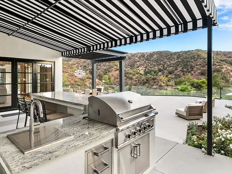 Covered BBQ and patio area has expansive views of the Beverly Hills.