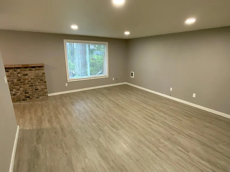 Living area w/ new flooring & fresh paint