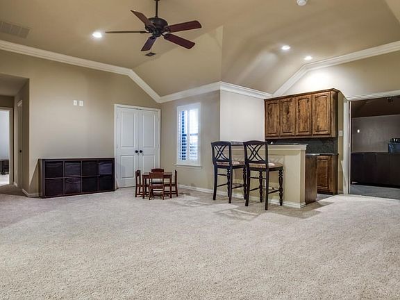 Game room with wet bar complete with granite counters.