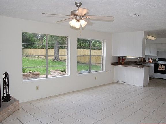 Den with large windows letting in natural light