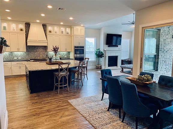 The breakfast room has wood tile too and enjoy meals with the sliding stacked doors open or closed, but still a great view to the back patio and yard.