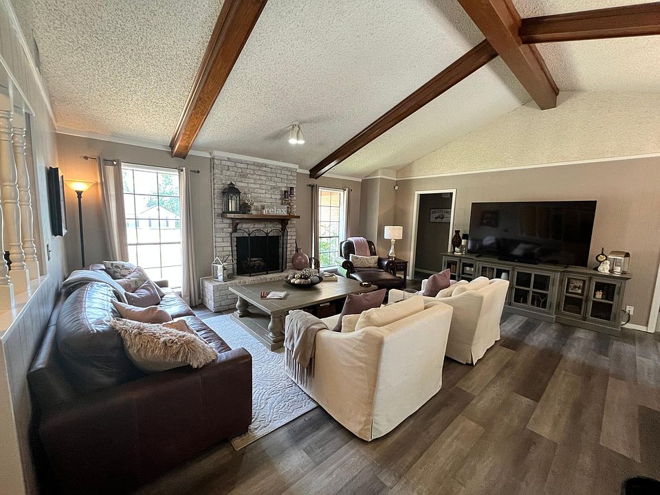 Beautiful living room with vaulted ceiling, gas fireplace and new flooring.