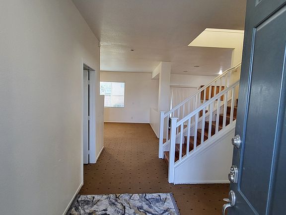 Entryway into home with downstairs room to the left.