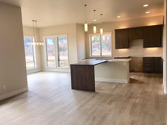 open floor plan/ great room, kitchen, dining area