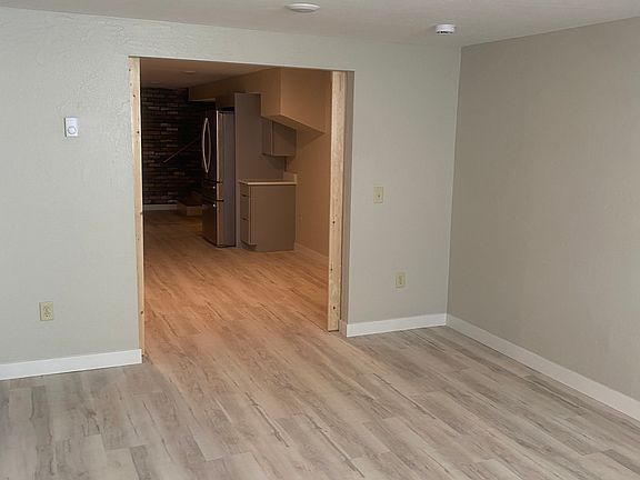 Bedroom with new flooring and recessed lighting.