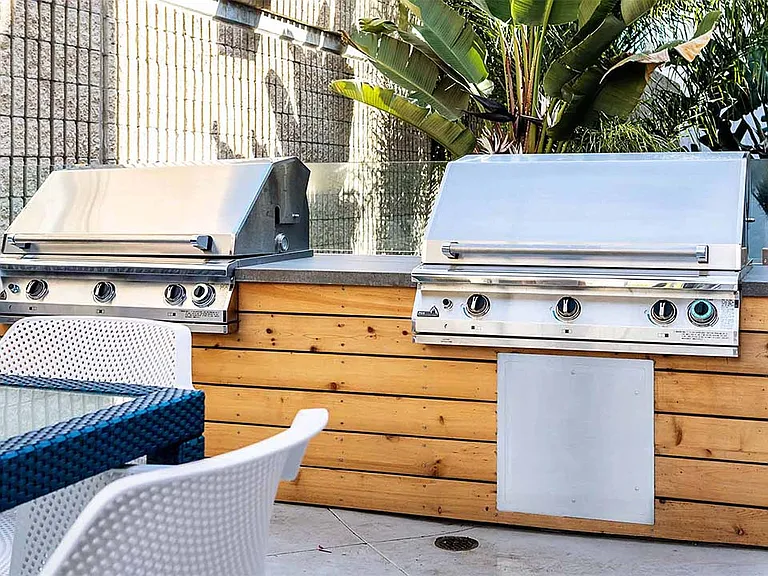 Apartment community outdoor grilling station at Griffis Pine Ave in Long Beach, California.