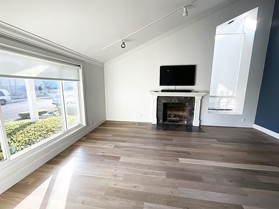 Living Room with soaring vaulted ceiling ~ Fireplace and TV