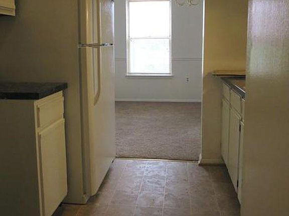 Kitchen with microwave, fridge, stove, and dishwasher. New cabinets are being installed this week, so a new photo is coming!