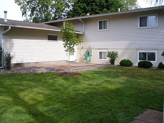 Backyard, with patio behind the garage, and new tree. (Olde